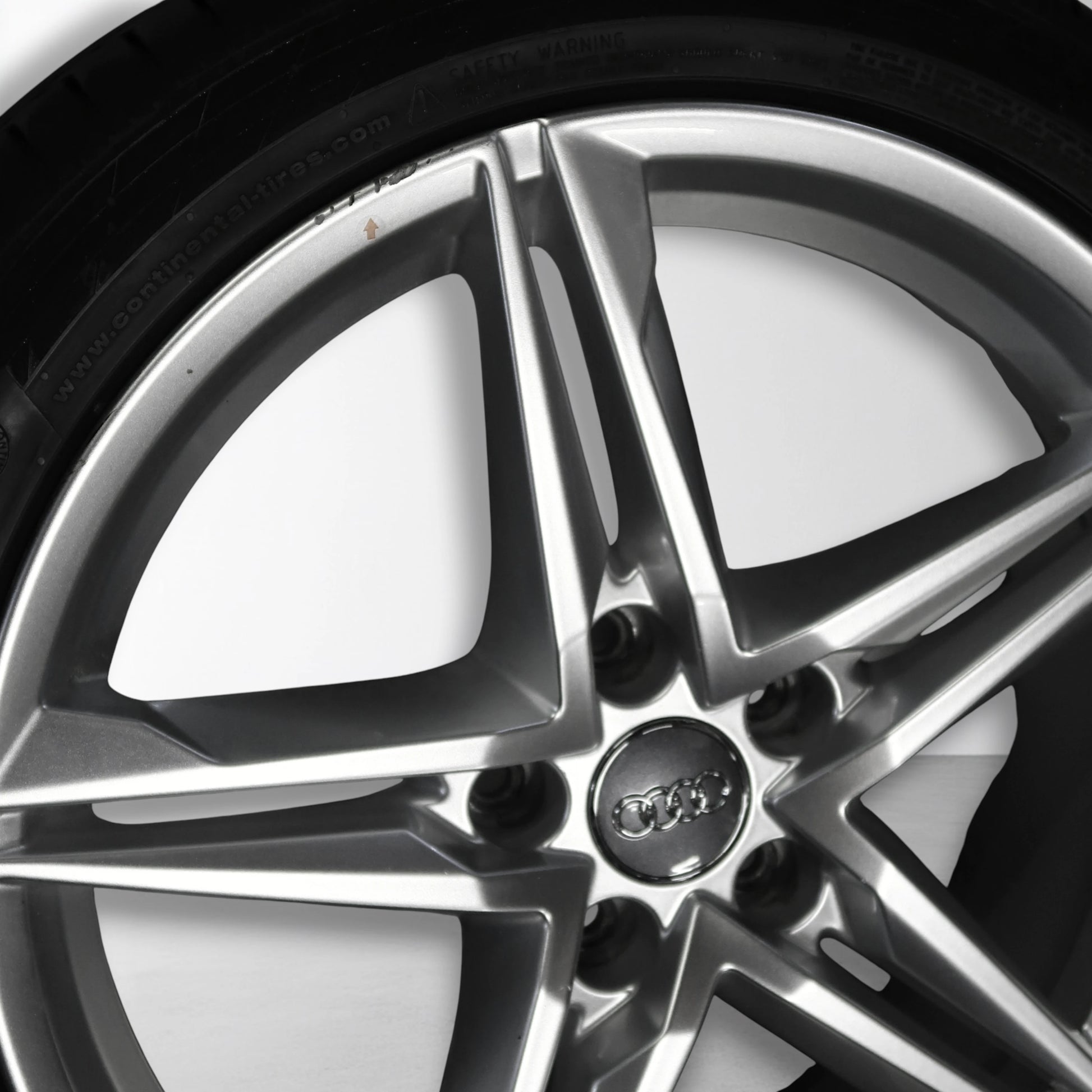 Zilveren 18-inch velg met spaken en centraal embleem